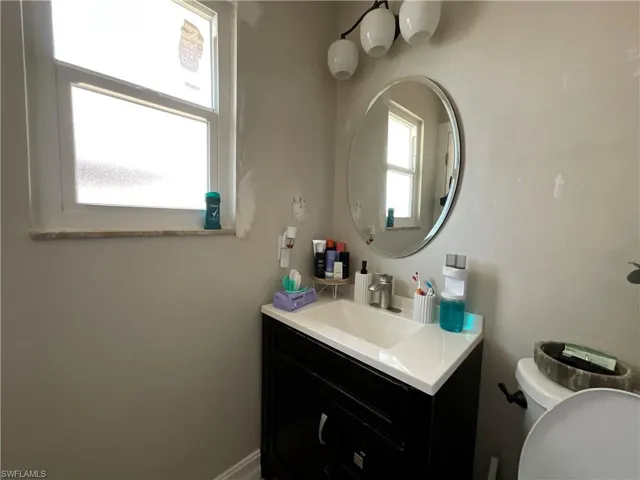 Half bathroom with vanity and toilet