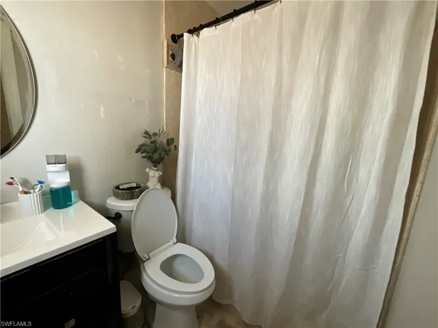 Bathroom with vanity and a shower with shower curtain