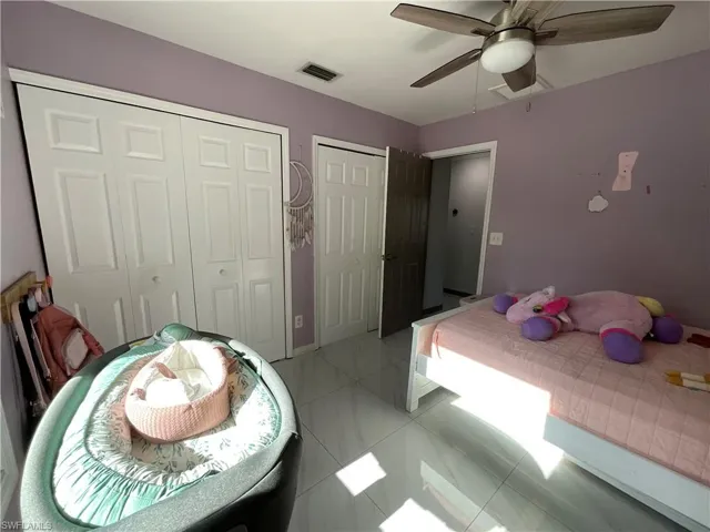 Bedroom featuring multiple closets and ceiling fan