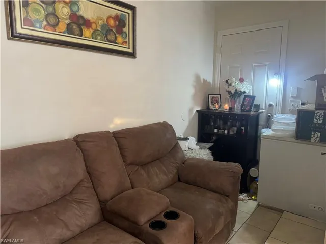 Living area featuring washer / clothes dryer and tile patterned floors