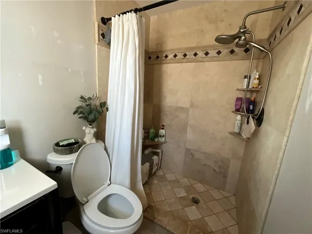 Full bathroom with a stall shower and vanity