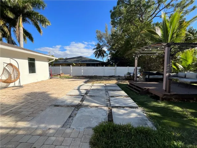 View of swimming pool featuring a wooden deck, patio surround, outdoor furniture, and a fenced backyard