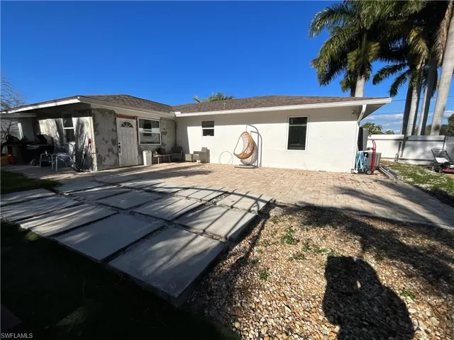 Back of property featuring stucco siding and a patio