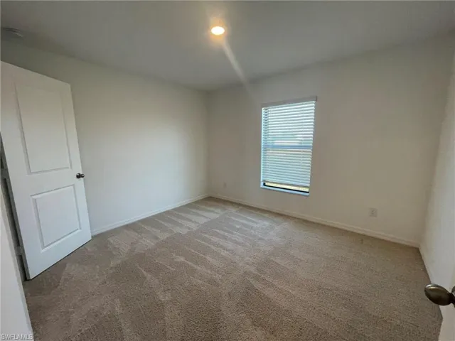 Empty room featuring carpet floors