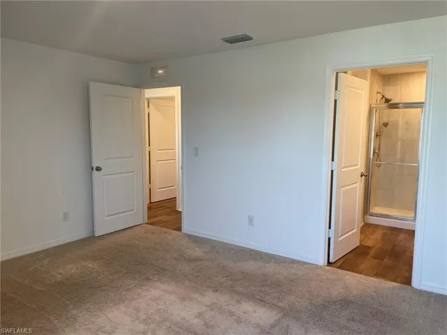 Unfurnished bedroom with carpet
