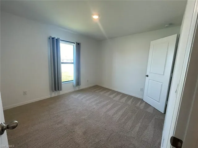 Empty room with carpet floors