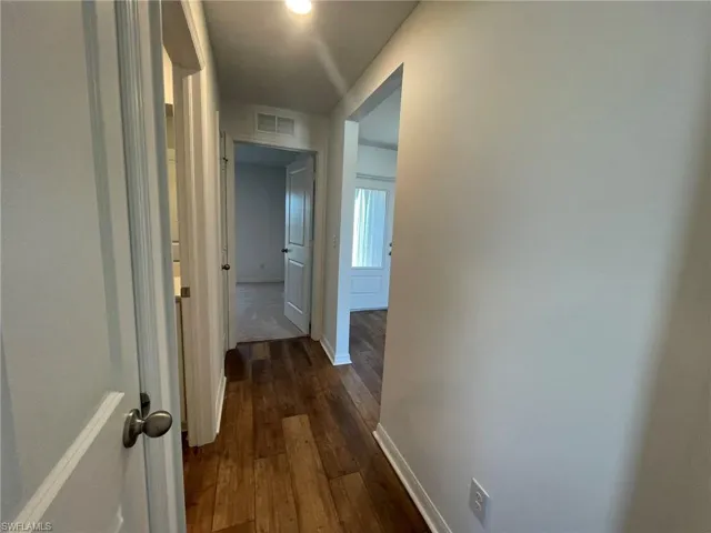 Corridor featuring dark hardwood / wood-style flooring