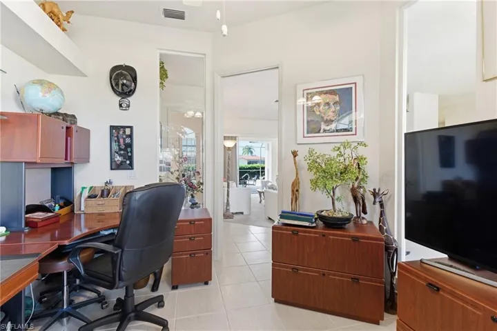 Office space with light tile patterned flooring and ceiling fan