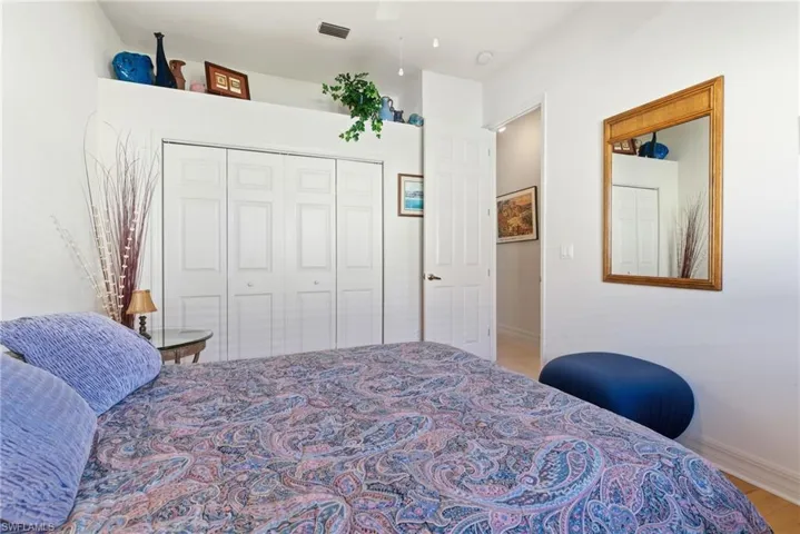 Bedroom with a closet, a ceiling fan, and light wood-style flooring
