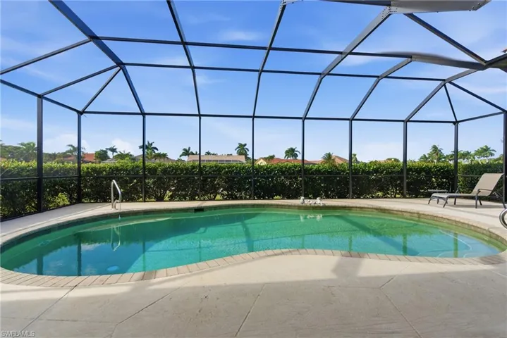Swimming pool with lanai and golf course view.