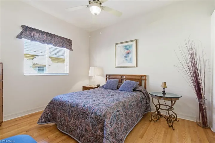 Bedroom with wood finished floors and a ceiling fan