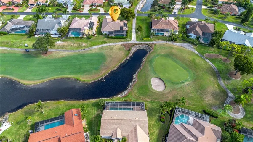 Aerial view of property and surrounding area with nearby suburban area and a golf club