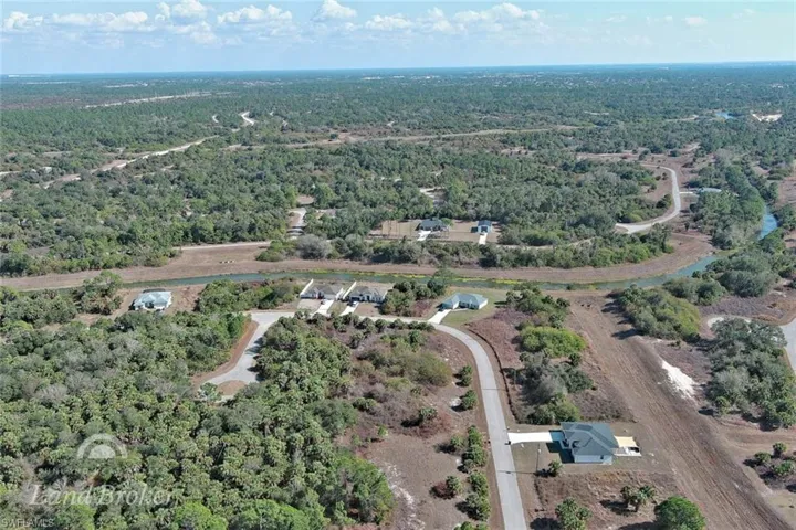 Aerial overview of property's location featuring a forest
