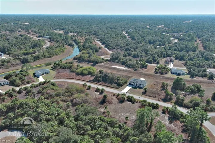 View of property location with a heavily wooded area
