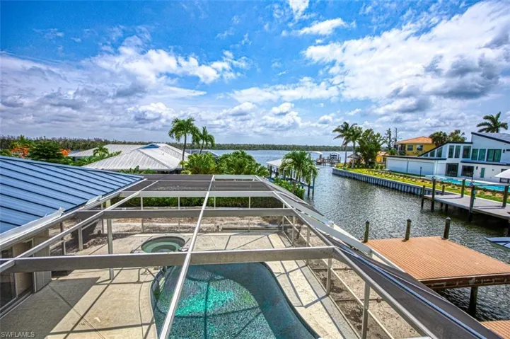 View of pool and Estero Bay from upstairs Primary Suite Balcony