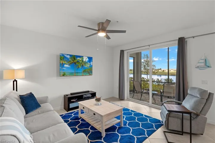 Living room with light tile patterned floors and ceiling fan