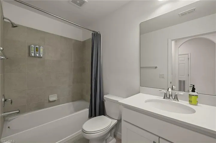 Full bathroom with vanity, toilet, and shower / bath combo