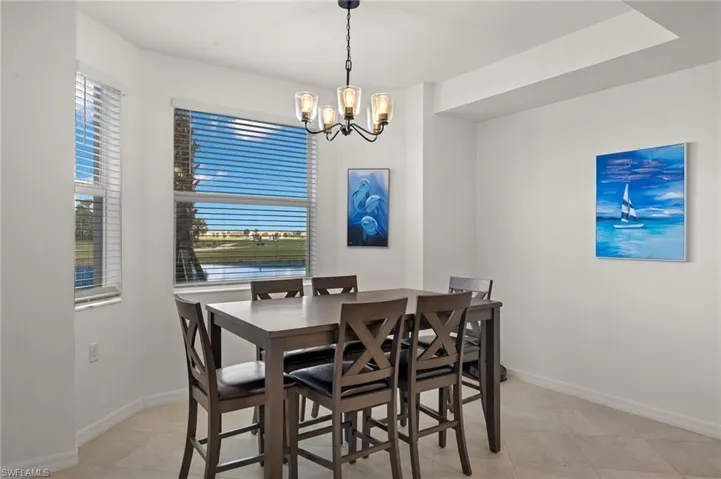 Dining space with an inviting chandelier and light tile patterned floors