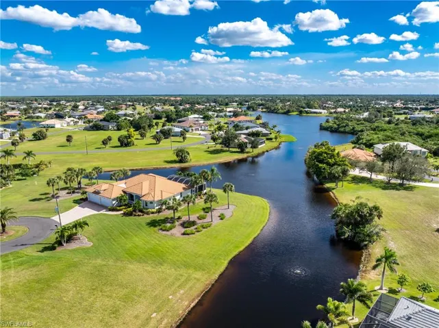 Aerial perspective of suburban area featuring a large body of water