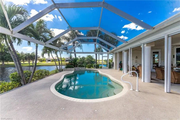 Outdoor pool with a patio, a sunroom, and a lanai
