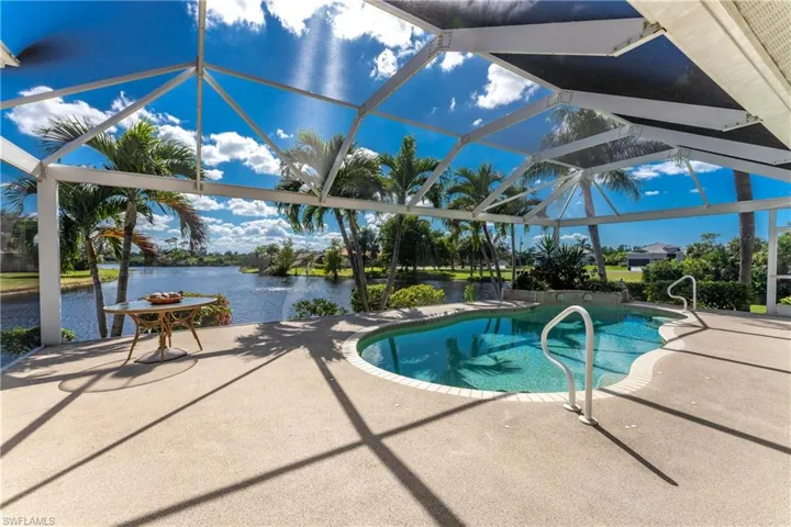 Outdoor pool with a lanai, a patio area, and a sunroom