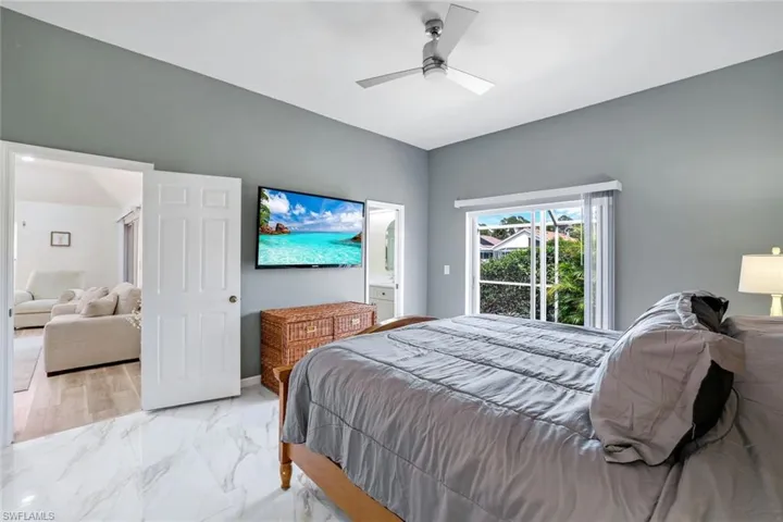 Bedroom with marble finish floor and ceiling fan