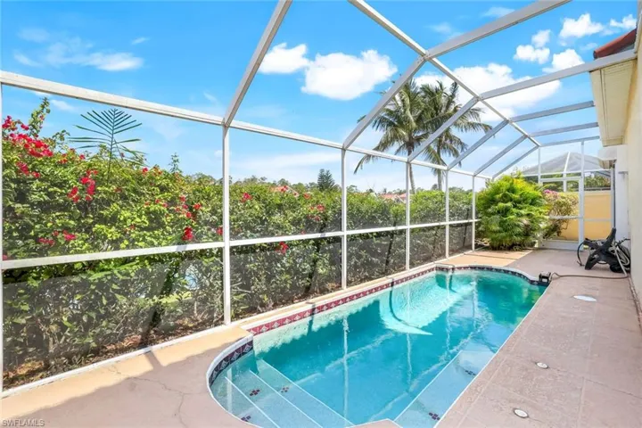 Pool with a lanai and a patio
