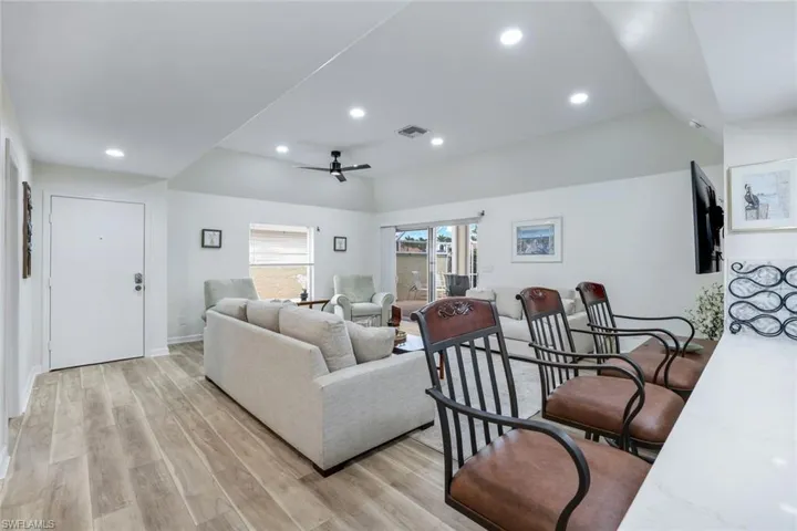 Living area featuring a ceiling fan, visible vents, recessed lighting, and light wood-style flooring