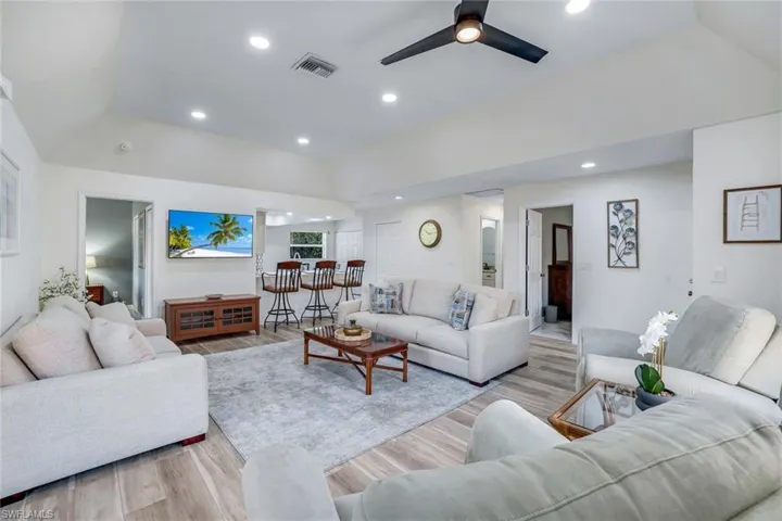 Living area featuring a ceiling fan, visible vents, recessed lighting, and light wood-style flooring
