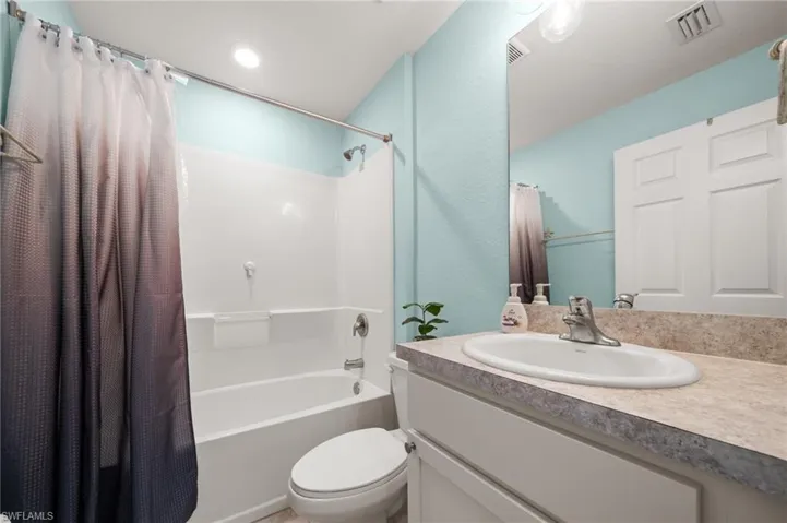 Full bathroom with shower / tub combo and vanity