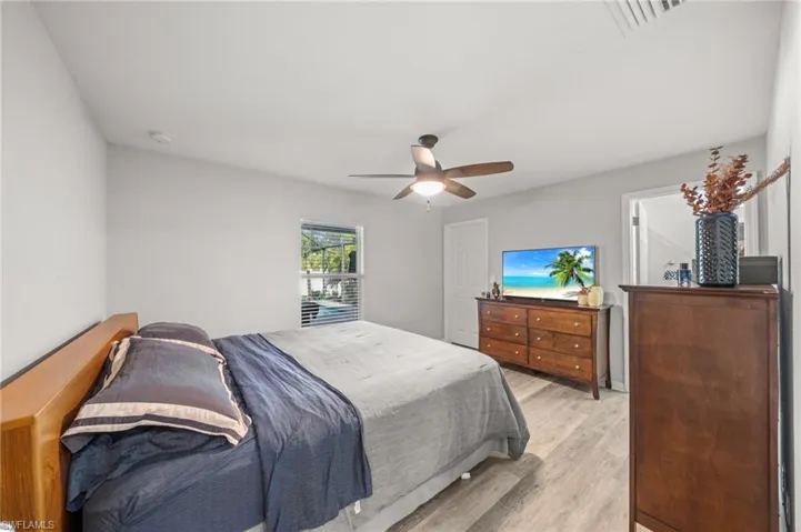 Bedroom with light wood-style floors and a ceiling fan