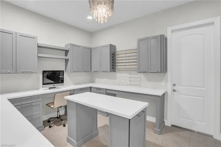 Extended laundry room for hobby/flex room. Crafting wall, desk setup, ample cabinets for storage