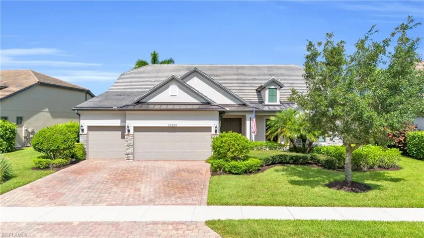View of front of property with a garage and a front yard