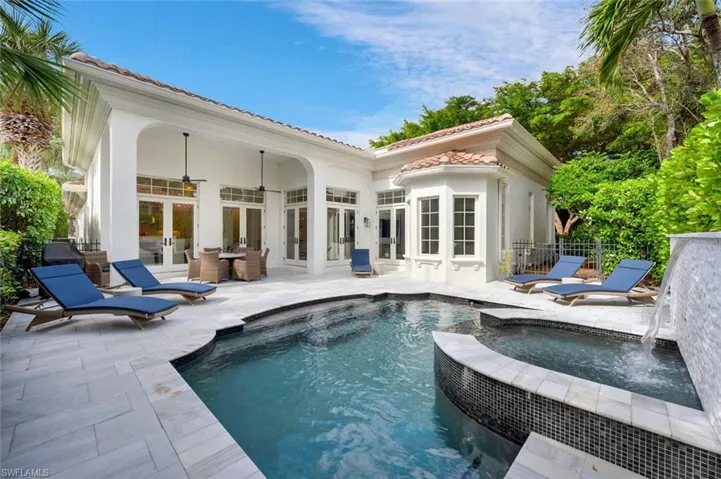 View of pool with french doors, an in ground hot tub, a patio area, ceiling fan, and pool water feature