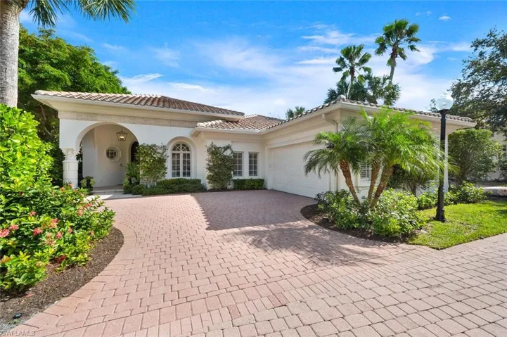 Mediterranean / spanish-style house with a garage