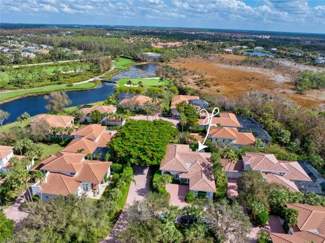 Birds eye view of property with a water view