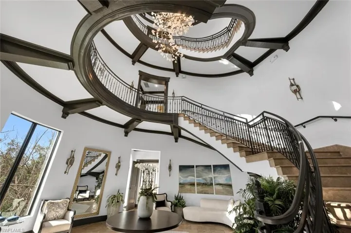 Stairway with a high ceiling and an inviting chandelier
