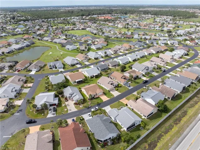 Aerial view of property and surrounding area with nearby suburban area and a nearby body of water