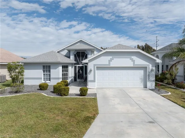 Ranch-style home with an attached garage, a front lawn, driveway, cooling unit, and stucco siding
