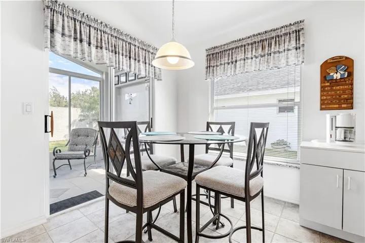 Dining space with baseboards and light tile patterned flooring