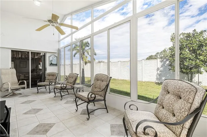 Sunroom featuring a ceiling fan and plenty of natural light