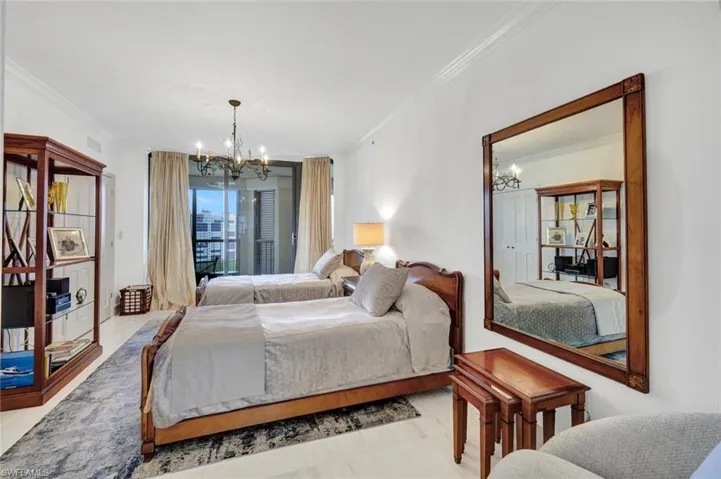 Bedroom with a chandelier and ornamental molding