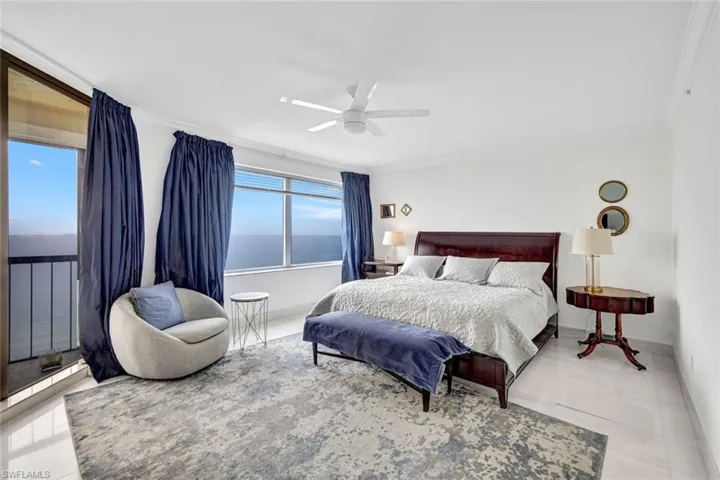Bedroom featuring a ceiling fan and ornamental molding