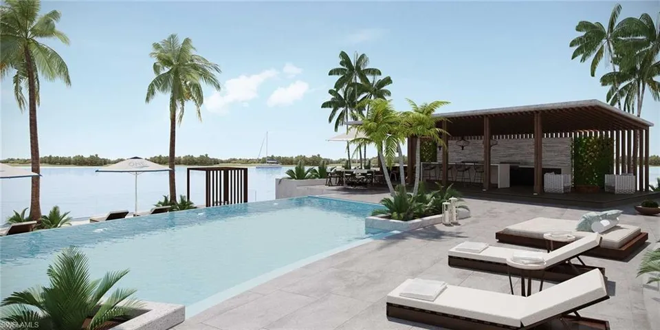 View of swimming pool with a water view and a patio area