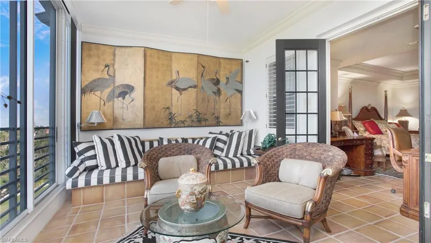 Sitting room featuring tile patterned flooring, crown molding, and ceiling fan