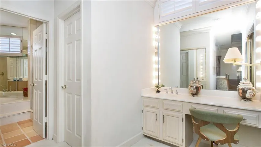 Bathroom with vanity, crown molding, and tile patterned floors