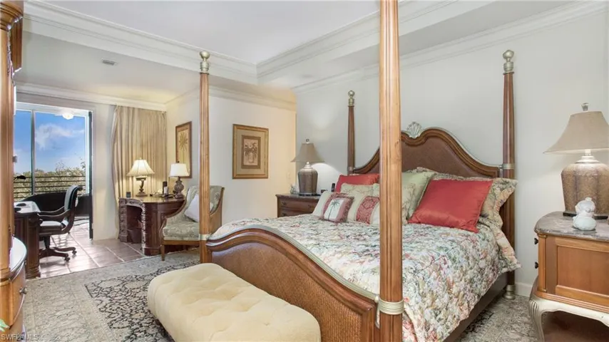 Tiled bedroom featuring crown molding