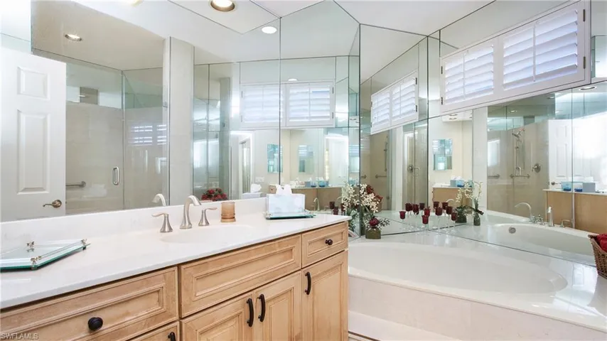Bathroom featuring vanity and shower with separate bathtub
