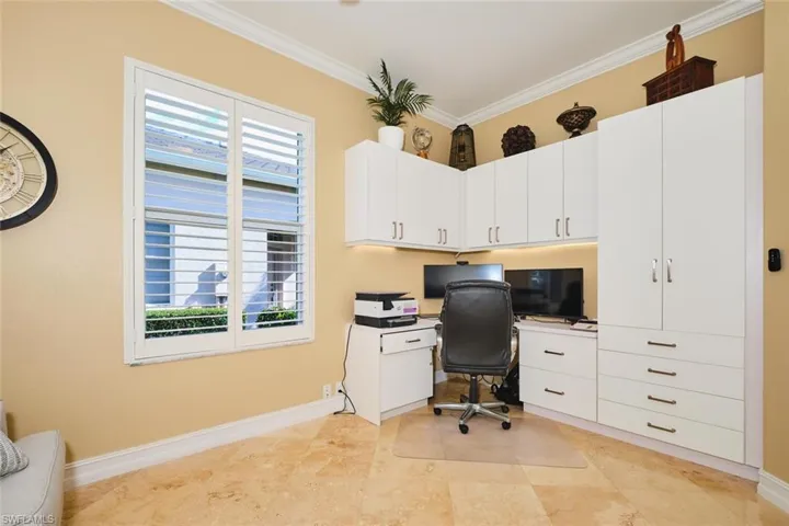Office featuring ornamental molding and built in study area