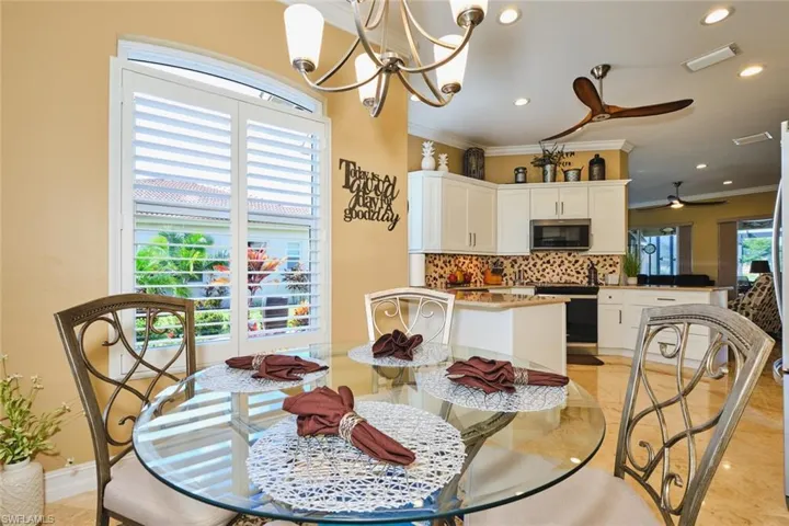 Dining room featuring a chandelier, ornamental molding, ceiling fan, and recessed lighting